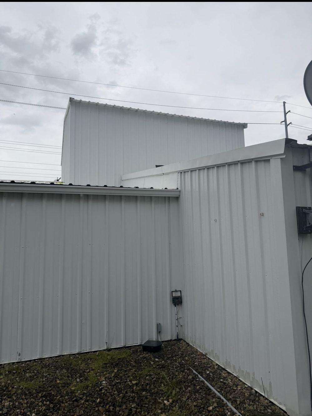 The same siding after low-pressure soft washing, clean panels with no streaking